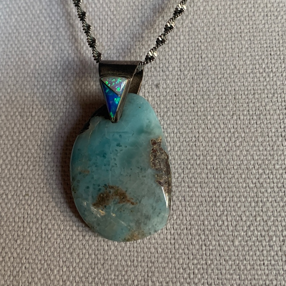 Opalesque pendant. 1 1/2”.Shades of Blues greens.